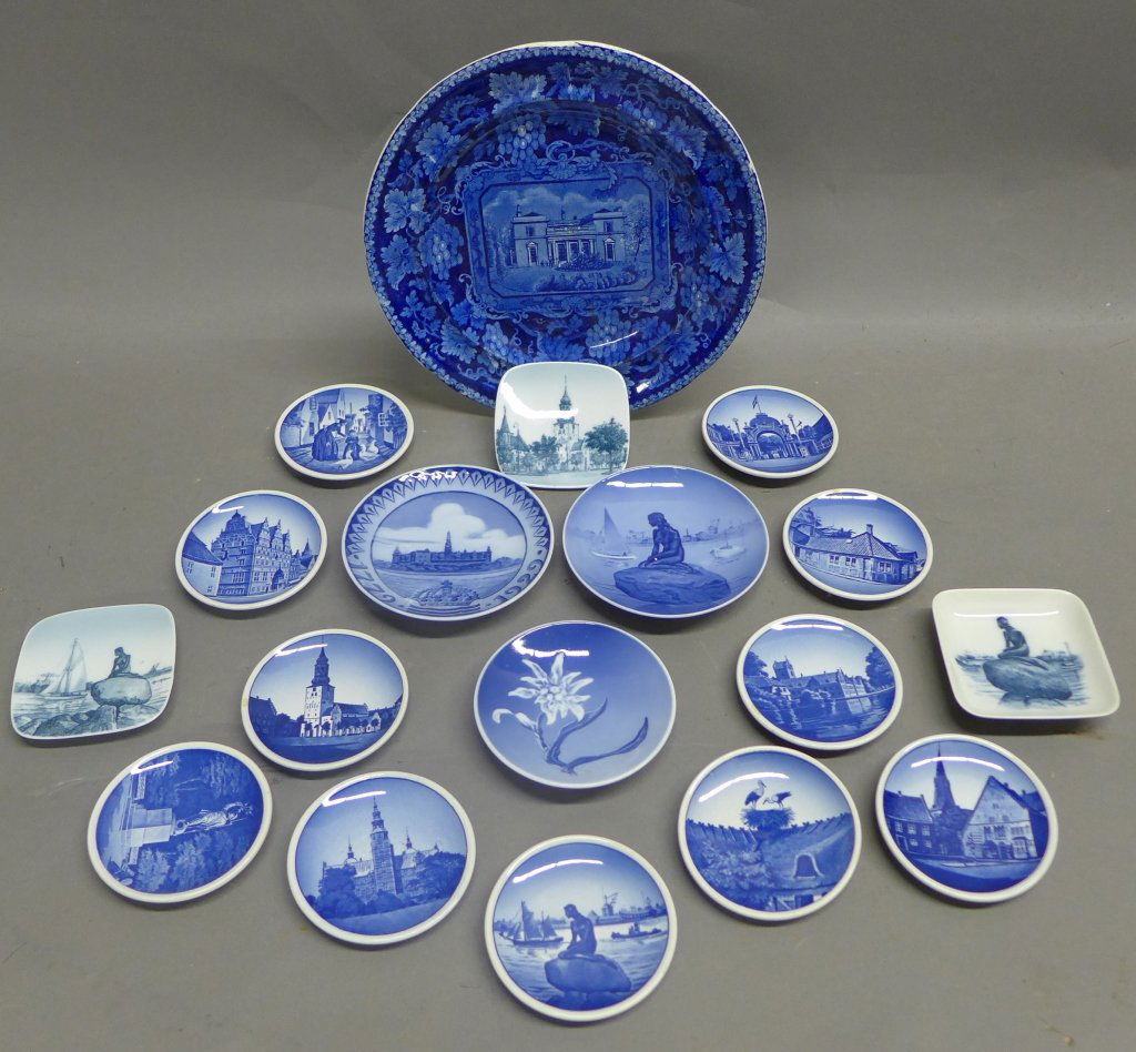 Assorted Royal Copenhagen Blue and White Plates: 18 pieces of blue and white porcelain collector plates, plaques and dishes. All have beautiful imagery/ painted scenes on front. Landmarks, landscapes, floral and figural scenes. Maker's mark on back