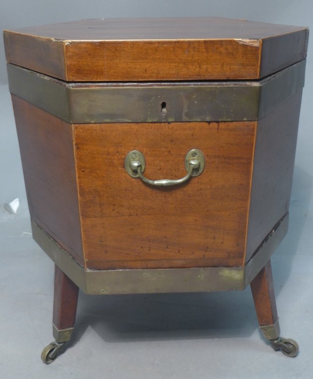 18th / 19th Century Cellarette: 18th / 19th Century Cellarette. Antique wood wine cooler has a hexagon shape. The top is hinged and the body has two broad brass bindings and brass handles. The interior is lined with metal. The coole