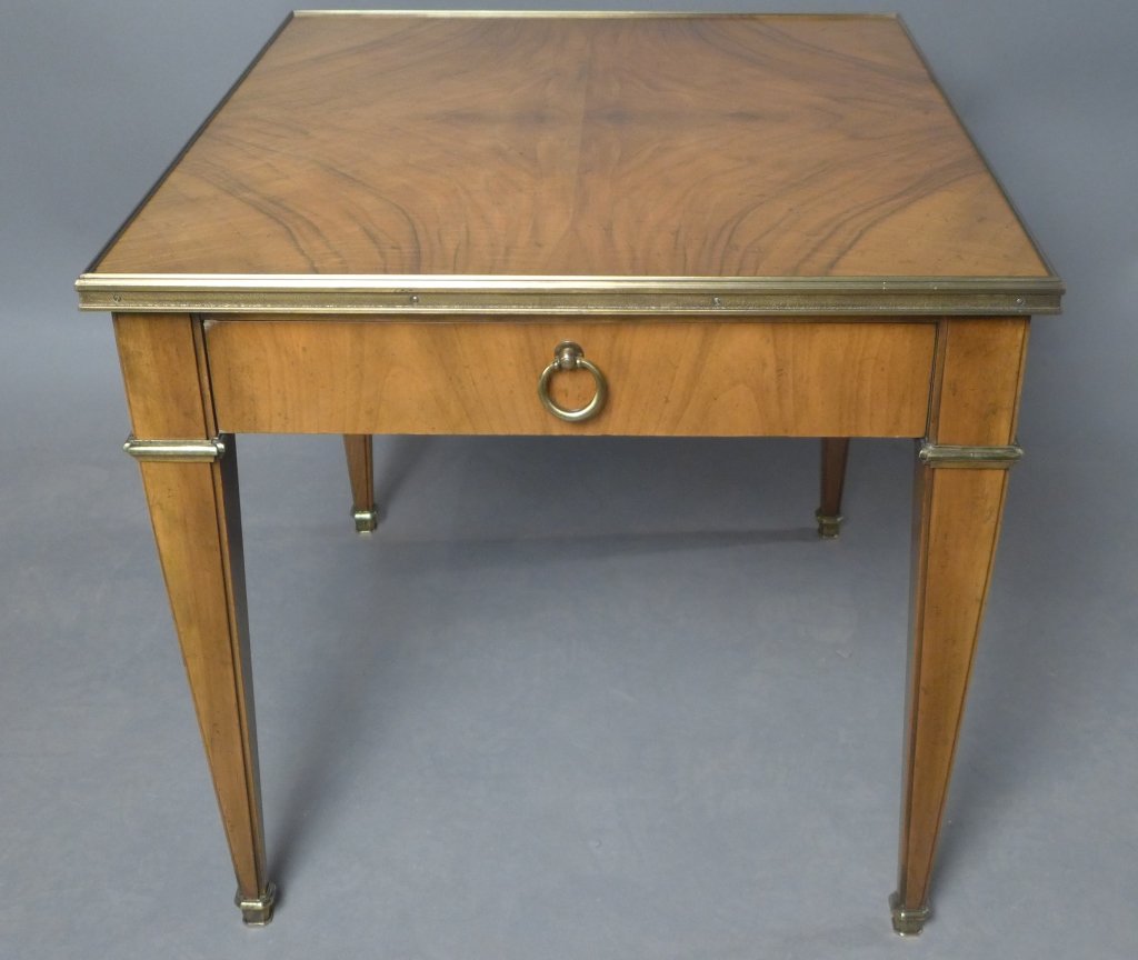Baker Furniture End Table: Wood end table with bronze mounts and 1 drawer. Tapered rectangular legs. Maker's mark reads: Baker Furniture. Height: 23 1/4", Width: 24 1/4", Depth: 27 1/4"(furniture, storage, side table, accent ta