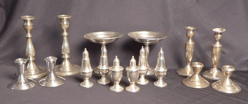 Assortment of Sterling Silver Table Accessories: Assortment of weighted sterling silver table accessories. Including one pair of compotes, four pairs of candlesticks and three pairs of salt & pepper shakers. One of the candlesticks has damage on the