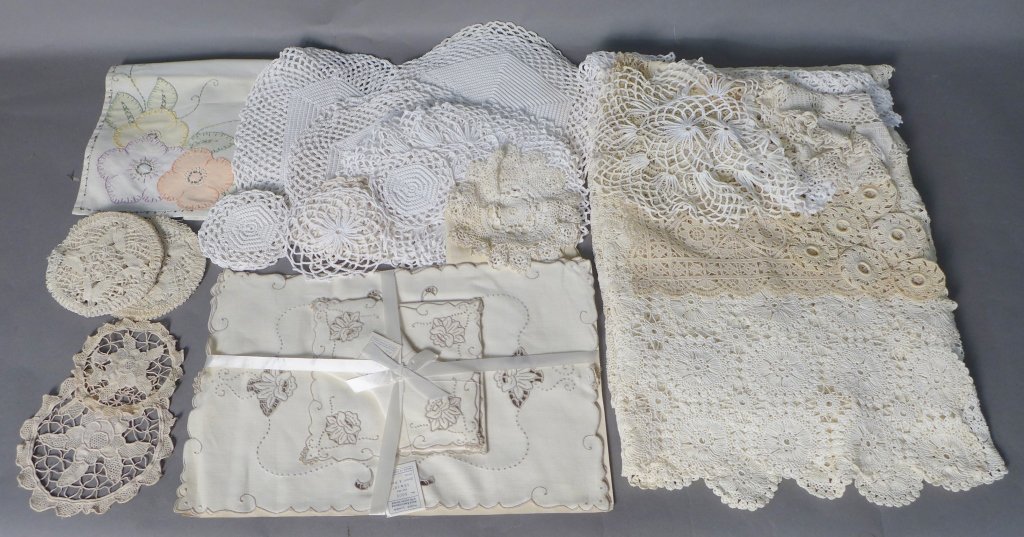 Assortment of Vintage Hand Embroidered Linens: Assortment of antique hand embroidered linens of various shapes, colors and texture. Includes various round matching doilies, various rectangle doilies, several place mats, various linens and a hand-e