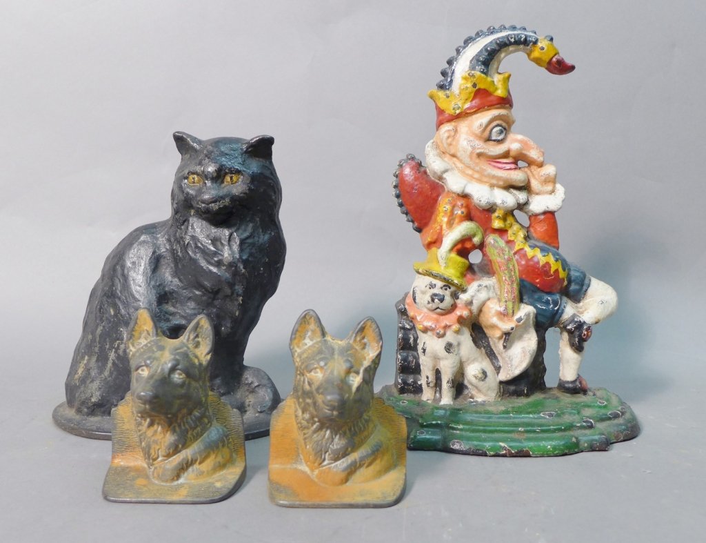 Assortment of Antique Door Stops and Bookends: Lot of antique iron door stops and bookends. Includes: cold painted Victorian cast iron "Mr Punch Doorstop". Possible original paint. Height: 12", Width: 9", Depth: 3 1/2". Antique cast iron cat with