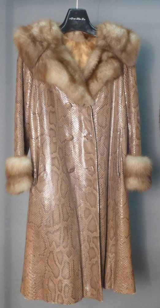 Long Vintage Fur Coat: Vintage fur coat. Long tan color fur coat, featuring possible snake skin on the outside with mink fur collar, sleeves and inside. Six buttons closure. Small hole under armpit. Length: 42" Imperfection