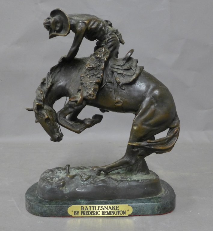 After: Frederic Remington, American (1861- 1909): Patinates bronze figural sculpture of cowboy on horseback. On mottled green marble base. Signed on base: Frederic Remington. Plaque reads: Rattlesnake by Frederic Remington. Height: 11 1/2", Width: 9"