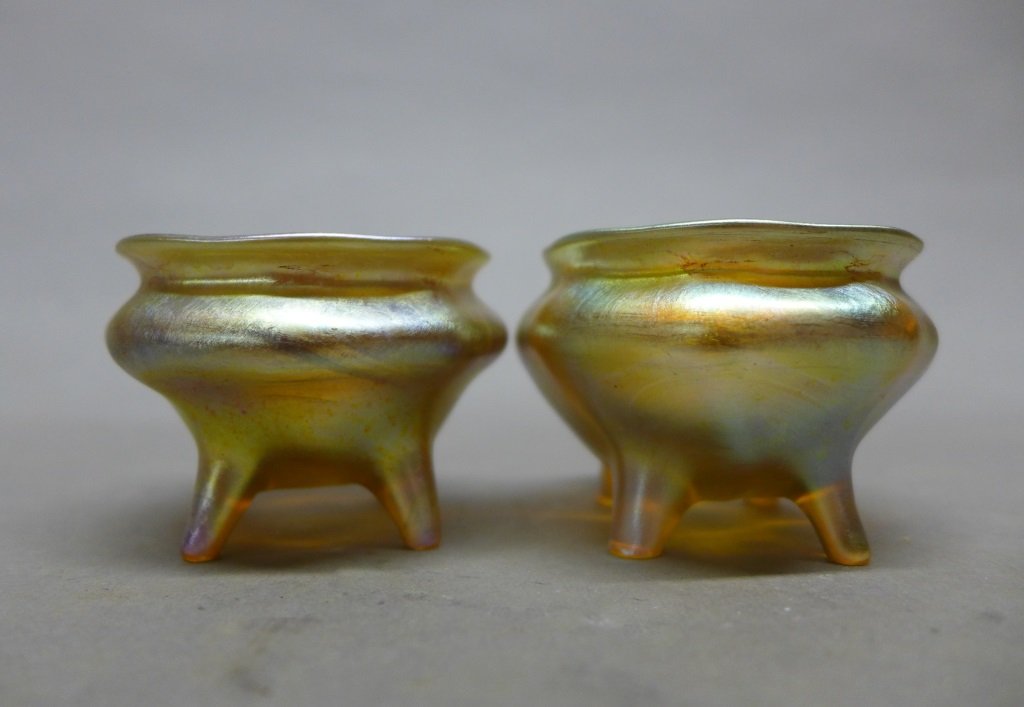 Pair Tiffany & Co Salts: Pair beautiful Louis Comfort Tiffany footed favrile salts. Marked on bottom: LCT. Height: 1 1/2", Width: 2 1/4" (studio glass, art glass, modern, mid century) STERLING ASSOCIATES STRIVES TO PROVIDE AC