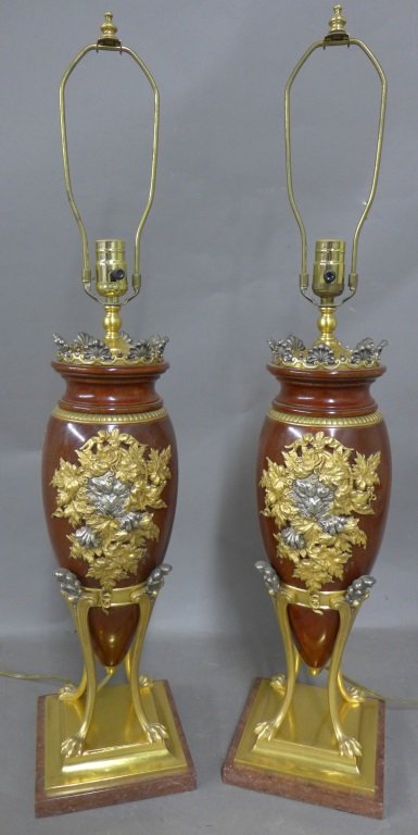 Pair Stunning Christofle Lamps: Beautiful walnut lamps with silvered and dore over bronze figural elements. Wood body is a tapering urn shape that rests on sculpted animal paw feet. On square red marble bases. No noticeable signatur