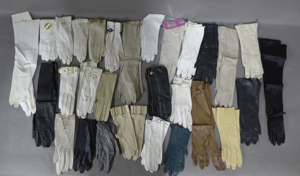 29 Pairs on Woman's Gloves: Large collection of lady's gloves includes different shapes, styles, lengths, colors and materials. Some have embroidered embellishments and others have gold tone metal accents. One pair is still in o