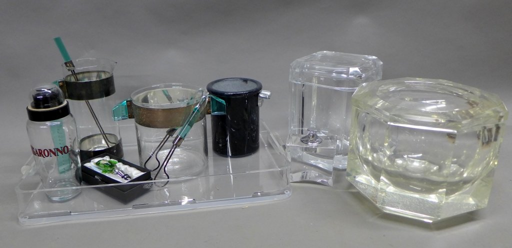 Modern Set of Bar Accessories: Collection includes: 2 Lucite geometric ice buckets with pivoting lids, Disaronno shaker/ measure, Murano glass wine stopper, marble wine chiller, table top lighter, Lucite tray, and matching set pitc