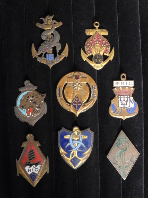 French Colonial Infantry Regiment Badges: Collection of 8 Colonial Infantry Regiment Badges of The French Foreign Legion. Includes: 1st, 6th RIC, 7th RIC, 10th, 11th RIC, 16 RIC, 22nd RIC & 41st. Height: 1 1/4" ; Width 2". Age appropriate wea