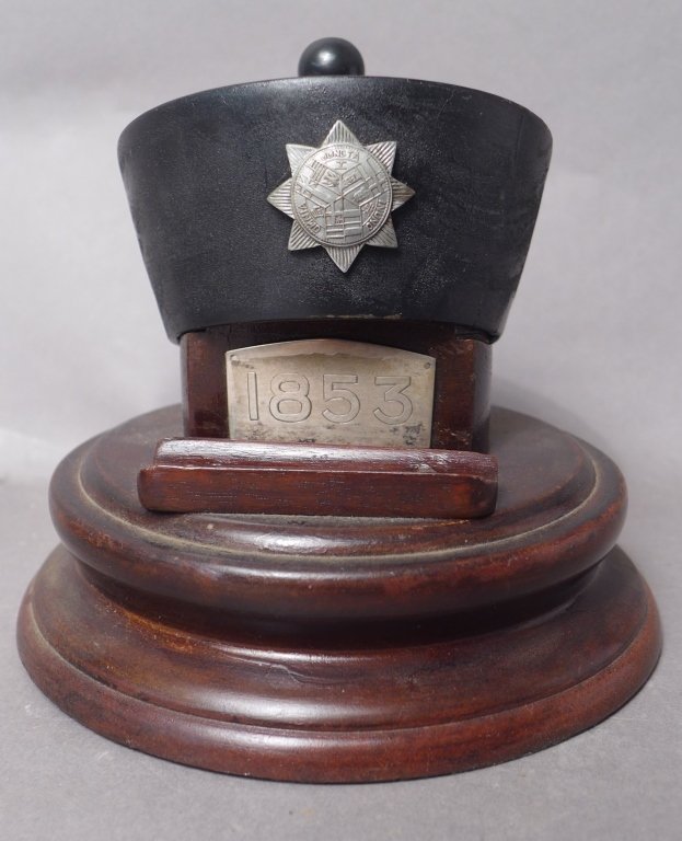 Shanghai Volunteer Corp. Pen Holder Stand: Shanghai Volunteer Corp. pen holder stand. Featuring black hat top with SVC eight pointed star badge on it, over dark wood base with metal plaque "1853". Imperfections. Height: 5", Diameter: 5 1/4" Fr