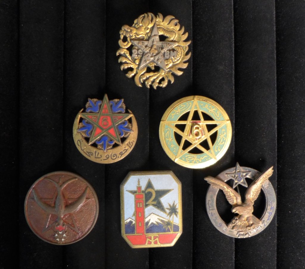 FFL Riflemen Regiments of Moroccans: Six assorted French Foreign Legion Riflemen regiments of Moroccans Badges. Includes: 1 R.T.M, 2 R.T.M, 3 R.T.M, 4 R.T.M - 2 B.M, 5 R.T.M and 6 R.T.M. Height: 1 1/2" ; Width: 1 1/8". Age appropriate we
