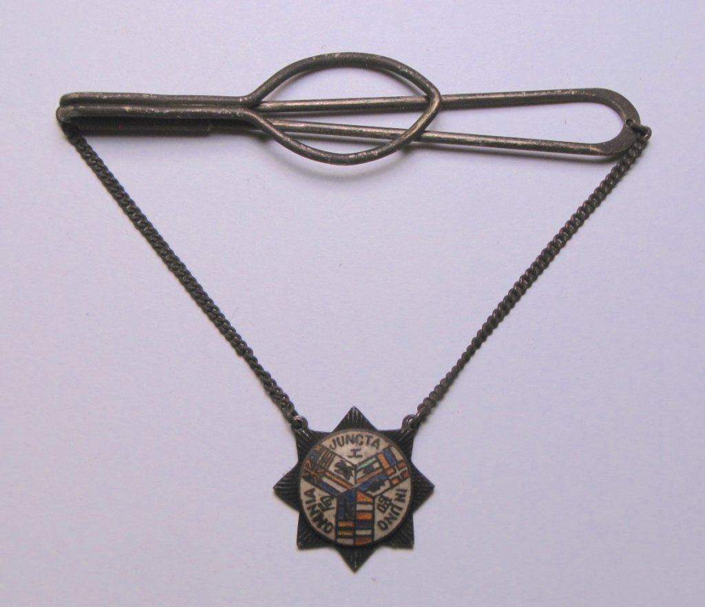 Silver Shanghai Volunteer Corps Suspension Clip: Rare Silver Shanghai Volunteer Corps suspension clip badge. Featuring small eight point star with white enamel background and colorful flags of all nations. Hallmarked on the back. Imperfections. Over