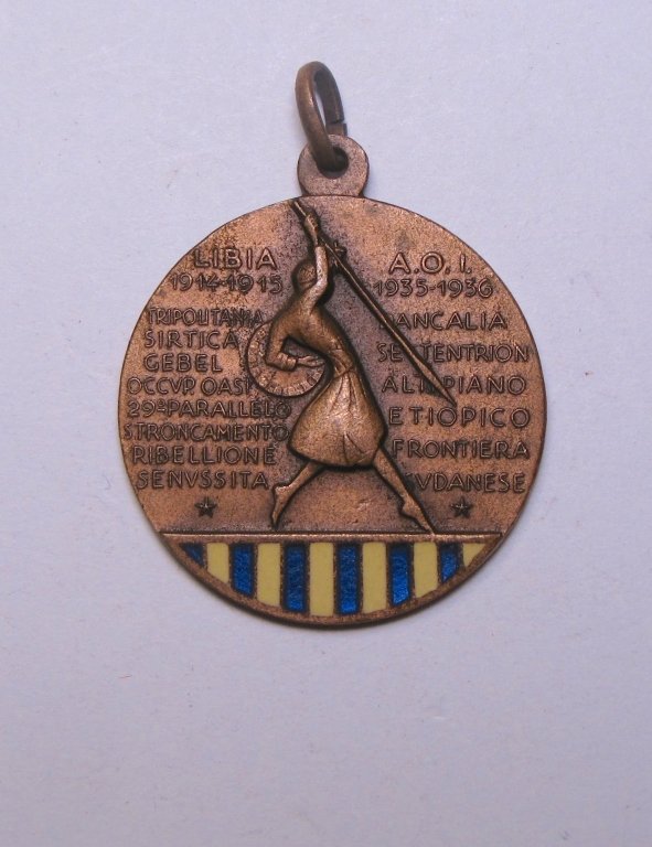 XIV Eritrean A.O.I Libya Boarder Sudanese Medal: Italian XIV Eritrean A.O.I Libya Boarder Sudanese Medal 1914-1915, 1933-1936. Decorated with blue and yellow enamel on the obverse, depicting a person with shield and spear. The reverse depicting jump