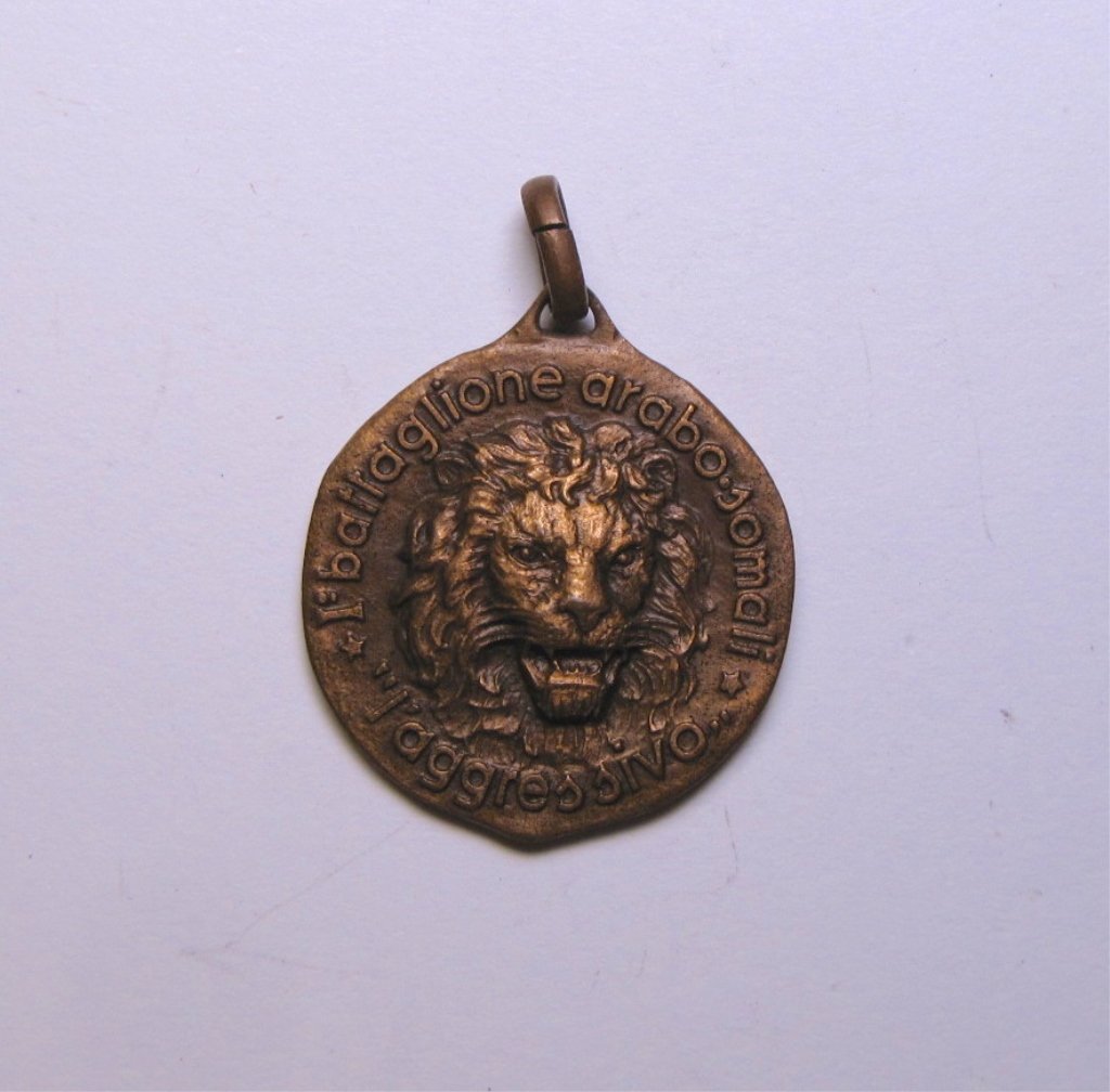 Bronze Medal of 1st Battalion Arabic Somali Africa: Bronze medal of 1st Battalion Arabic Somali Colonial Africa. The obverse is depicting a head of a angry lion and signed "I Battaglione / Arabo Somali / L'Aggressivo". The reverse is depicting blue and