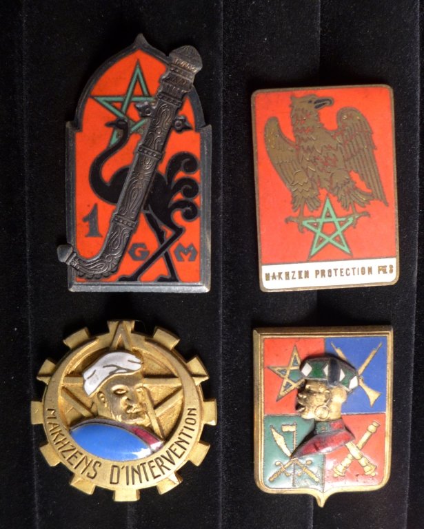 Badges of The Goums, Tabors and Moroccans: Four assorted French Foreign Legion badges of The Goums, Tabors and Moroccans. Includes: 1 Moroccan Goum, MAKHZENS INTERVENTION, Makhzen of FES Protection and Black Guard Sultan. Maker marks. From the