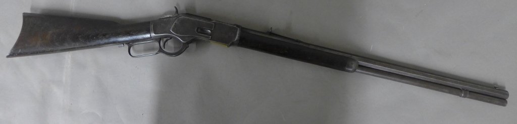 Antique American Winchester Rifle: Model 1873 Winchester Rifle. Octagonal barrel with the caliber marked on the top flat just in front of the breech “38 W.C.F.”Top of barrel is engraved: Winchester's Repeating Arms New Haven. Conn.