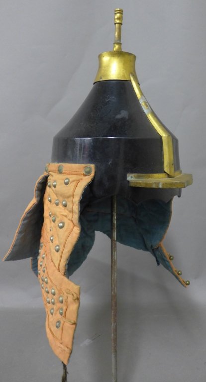 Antique Chinese Military Helmet: Chinese officer's helmet. Black body with brass accents and top finial. Fabric side and back neck guards have pattern of metal rivets and three ball clasp closures at front. Missing rivet, age appropr