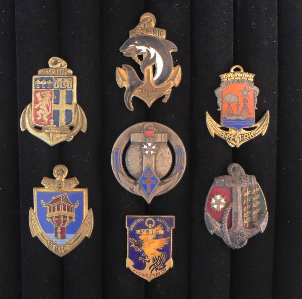 French Colonial Infantry Regiment Badges: Collection of 7 Colonial Infantry Regiment Badges of The French Foreign Legion. Includes: 1st, 4th, 6th RIC, 9th RIC, BM/11 RIC (D rom), 21st RIC & 43rd RIC. Maker marks. From the collection of Gene C