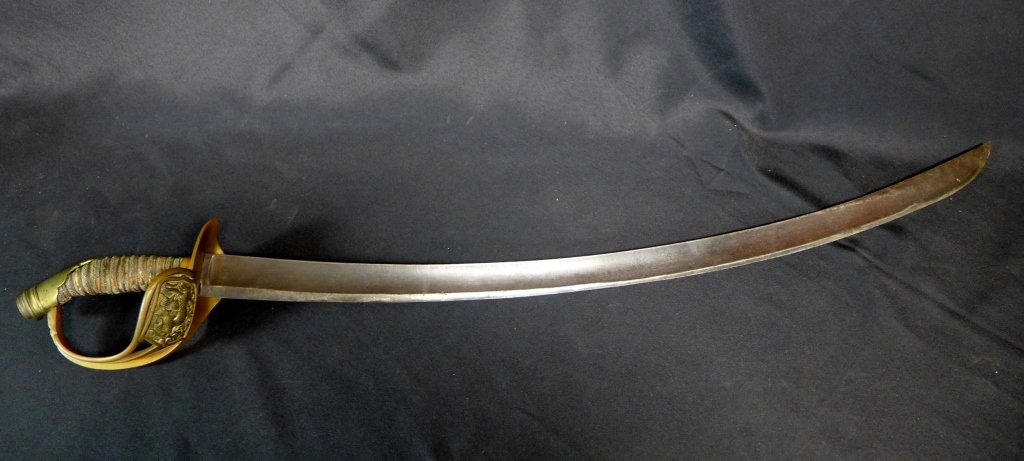 Antique Calvary Saber: Antique Calvary Saber. Guard adorned with a repose dragon. Handle is wire-wrapped leather or other animal skin. No Scabbard. Maker marks. Height: 36 3/4" ; Width: 5", Depth: 3". Age appropriate wear. 