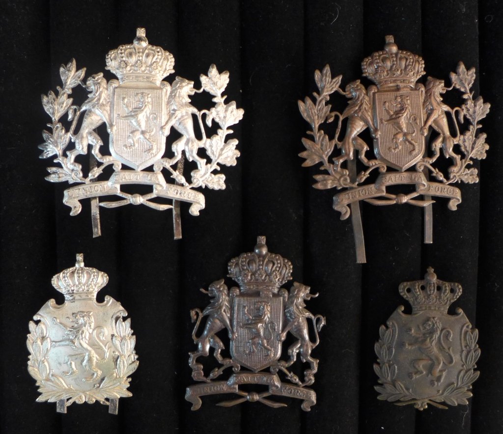 Belgian / British Cap Badges: Collection of 5 Belgian Cap Badges. Includes: British Belgian cap badge L'Union fait la force, Cap badge Belgian Colonial Troops - Forces Publique From the collection of Gene Christian. Height: 3" ; W