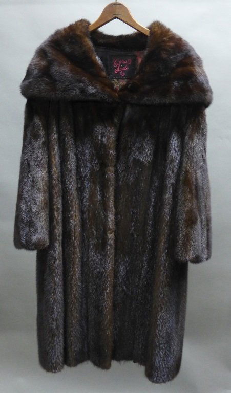 Vintage Mink Coat: Long brown soft mink coat. Embroidered detail at top by collar reads: Cora Sinde. Inside lining has lovely floral pattern Missing 2 out of 3 hook closures in front. Some areas of separation of lining