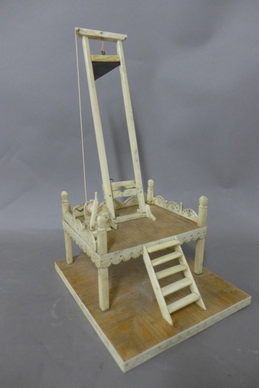 Vintage Hand Made Carved Guillotine Prison Art: Vintage hand made carved guillotine sculpture, Devil's Island prison art, circa 1920s. Featuring wooden base with carved white natural material guillotine contraction with pierced design. Very detaile