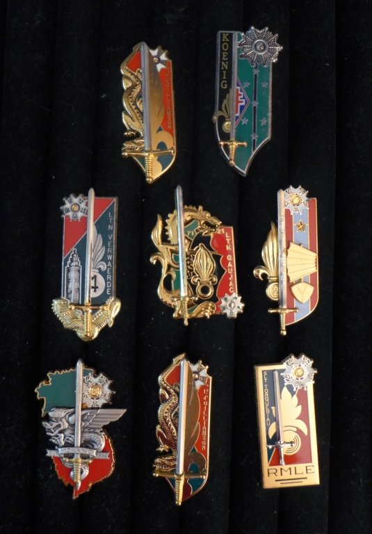 Collection of 8 FFL School Promotion Badges: Collection of 8 French Foreign Legion Promotion Badges.Includes: LT D' Oilliamson, SLT Morand 1954, 21 LTN Gaujac, SLT Merel and more.Maker marks. Possible re-strikes. From the collection of Gene Chri