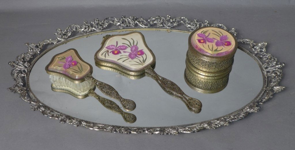 Vintage Dresser Set with Mirror Tray: Four piece vintage vanity set with beautiful ormolu and pierced design. Large silver tone oval mirrored tray has scrolling floral fence. Round powder box, hand mirror and hair brush all have lovely fl