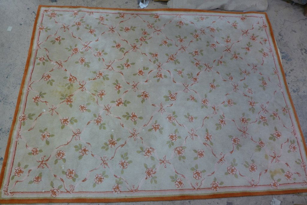 Large Retro Floral Rug: Large floral carpet with bows and floral design. Multi color rug with shades of pink, green and orange on a cream background. Maker's label on bottom boarder reads: Edward Fields Inc. copyright 1969.