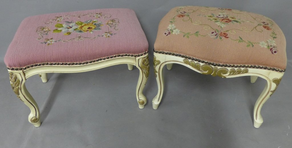 Pair Victorian Style Footstools: Two needlepoint petitpoint ottomans with floral embroidery on cushion and nail head design on side. Both stools have painted and gilt wood base. Some imperfections. Measurements are (HxWxD): 15"x 17" 