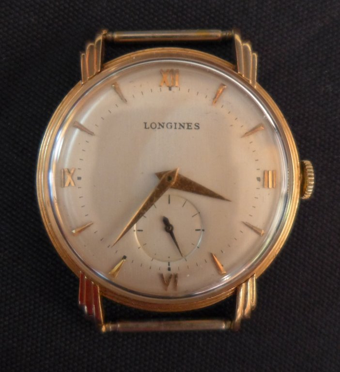 Longines Gold Men's Watch Face: Longines Gold Men's Watch Face. Longines yellow gold round face men's watch. No Band. Casing marked 14K. Manual winding. Age appropriate wear. Total weight: 26 grams. Height: 1 5/8";Width: 1 3/8". *As