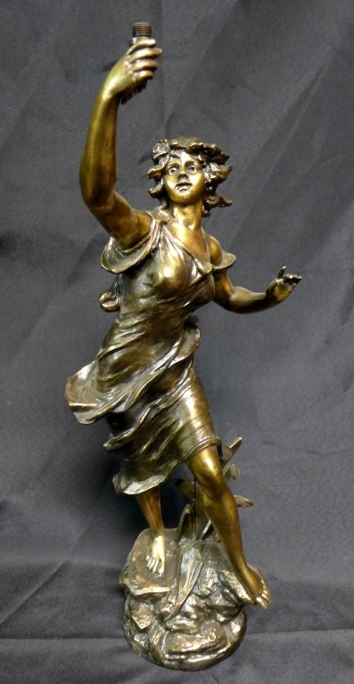 George Maxim (20th Century): Antique patinated spelter figural statue depicting a young woman with her hand raised. Paris France foundry mark on base. Circa 1900. Incised on base: Geo Maxim. Possibly fitted to be a swinging arm c