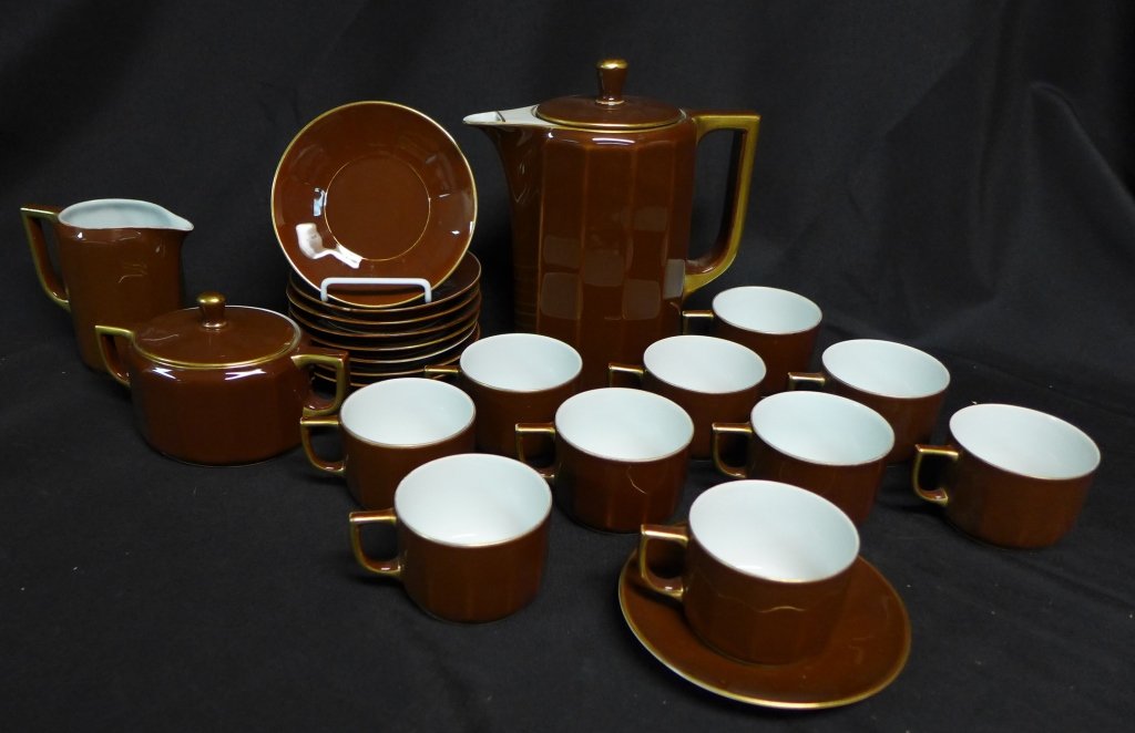 Rosenthal Wilhelmine Kronach-Bavaria Tea Set: Tea set is brown with gold trim. Vessels have white interiors. Collection includes: nine saucers, ten tea cups, covered sugar bowl, creamer and tea pot with lid. Maker's marks on bottom. Height: 9", W