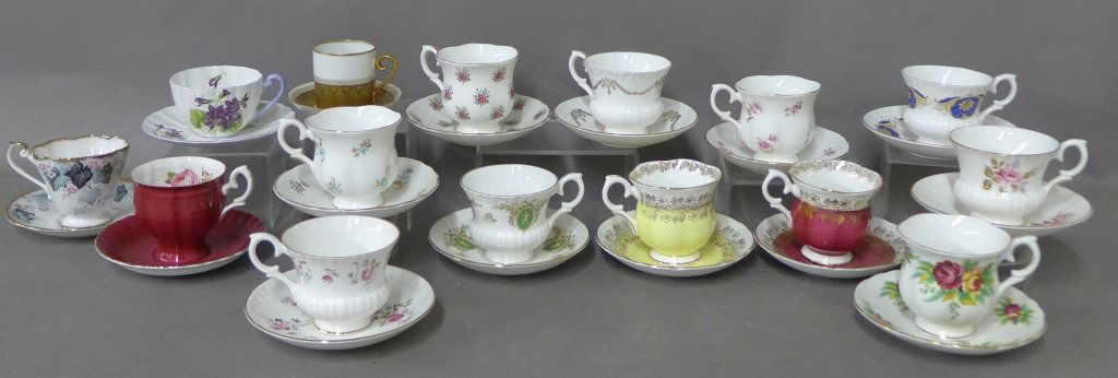 Fine Bone China Tea Cups & Saucers: 15 sets of tea cups and matching saucers. Sizes, shapes, styles and designs vary. Most have floral motif with gilt accents. All have maker's marks on bottom. 12 of the 15 have porcelain mark: Crown St