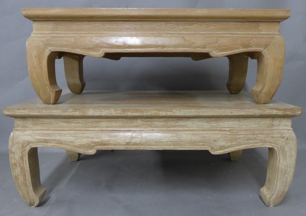 Pair of Teak Wood Tables: Thai Teakwood coffee tables from Karl Mann & Associates. Scalloped waist and natural finish. Low tables KMLP. No noticeable maker's marks. Height: 13", Width: 34", Depth: 20" & Height: 11", Width: 30"