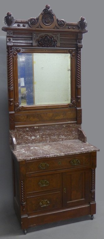 Italian Victorian Hotel Washstand, 19th C: Antique Italian Victorian carved walnut and marble top washstand. Antique mirror in wood frame pivots at center. Beautiful ornate mounts and drawer pulls. On caster wheels. Height: 86", Width: 32 1/4"