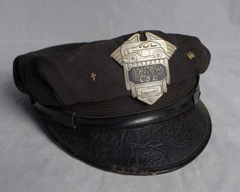 Vintage Taxi "Yellow Cab" Cap with Badge: Vintage Yellow Cab Taxi Cap with Badge and pins. 1940's YELLOW CAB TAXI DRIVER CAP WITH #92 BADGE and two side pins. Imperfections. Height: 4"; Width: 9 1/2"; Depth: 8". STERLING ASSOCIATES STRIVES TO