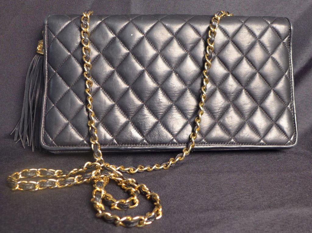 Chanel Quilted Black Leather Shoulder Bag: CHANEL Quilted Black Leather Shoulder Bag with Tassel Gold Chain - Vintage.Burgundy silk & leather interior.Height: 6 1/2"; Width: 11 1/2"; Depth: 2". Strap is about 20" long.Imperfections.NO CERTIFIC