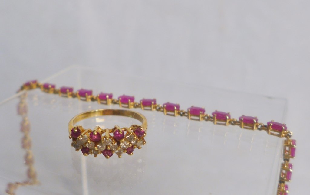 Ruby and Gold Ring and Bracelet Set: Ruby and Gold Ring and Bracelet Set. Ring features 14k yellow gold, 7 rubies and 13 diamonds set in a zig-zag formation. Bracelet has 25 rubies set in 14k yellow gold. Total approximate weight: 7 gram