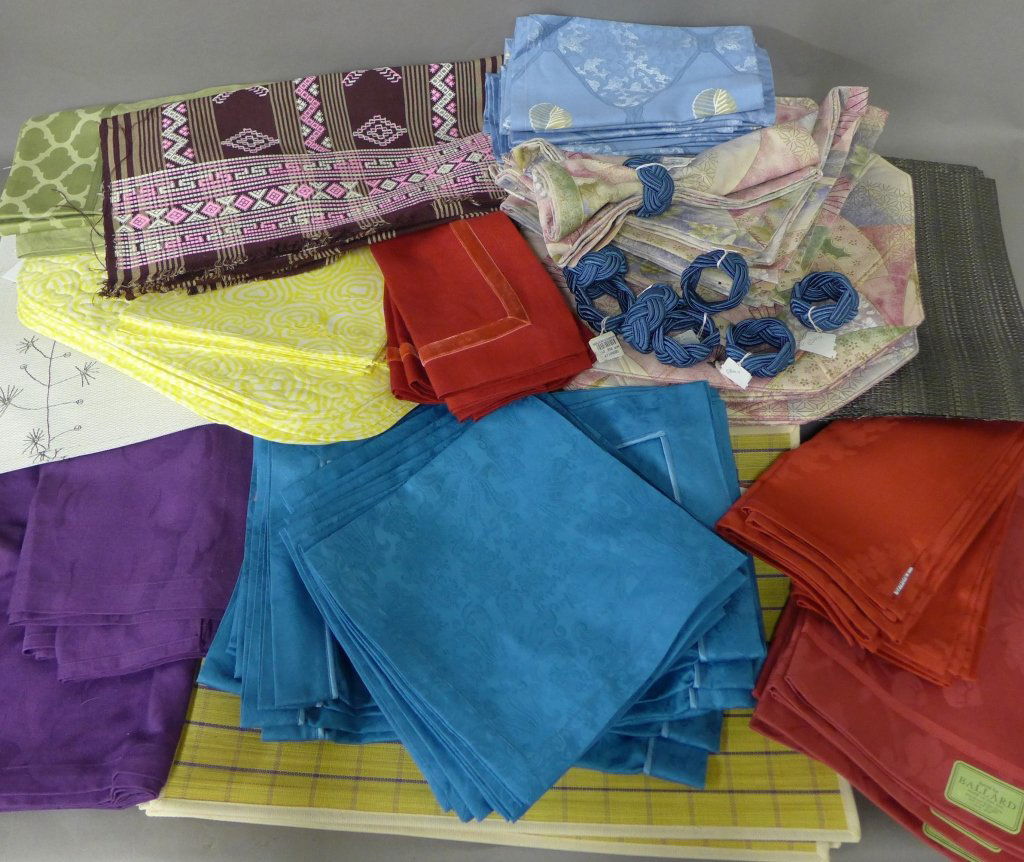 Large Grouping of Table Linens: Colors, materials, styles and sizes vary. Collection includes: -From Berdorf Goodman (all with tags): 8 reversible cloth place mats, 8 cloth napkins and 8 braided napkin rings. -From JESVRVM (also kno