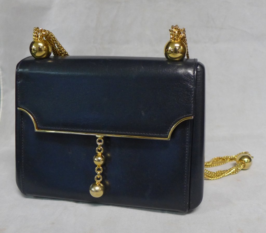 Mark Cross Scottie: Vintage navy leather evening purse with gilt metal accents and ball and chain shoulder strap. Maker's mark inside. Imperfections. Height (not including strap): 5 3/4", Width: 8", Depth: 2 3/4"(fashion