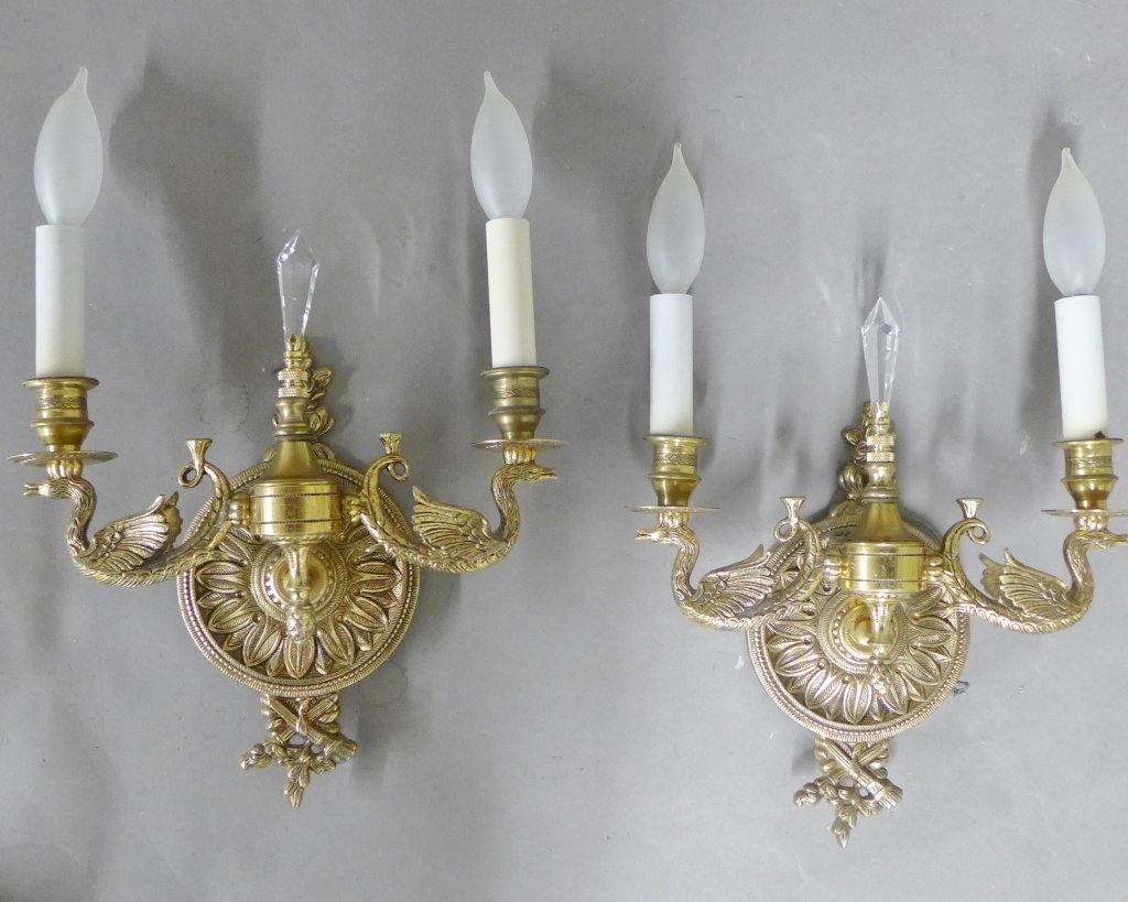 Pair Gilt Metal Swan Form Sconces: Spanish reproduction lighting, circa 1950. Crystal finial at center. Two arms as sculpted swans on either side. Noticeable old repair to one. Wired for electricity. Height: 12", Width: 10 5/8" (lighti