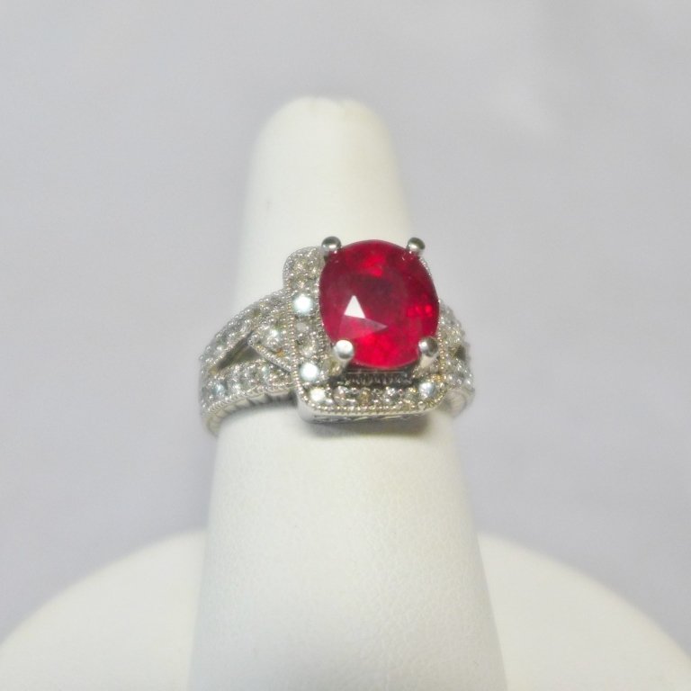 Diamond & Ruby Solitaire Ring: Diamond & Ruby Solitaire Ring. 14k white gold setting holds 44 round cut diamonds and a genuine 2.4 ct ruby. Certificate and pouch included. Ring size: 6 1/2. STERLING ASSOCIATES STRIVES TO PROVIDE AC