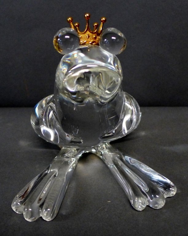 Steuben Glass Frog Prince w/ 18K Gold Crown: "Frog Prince" designed by Lloyd Atkins circa 1973. Clear crystal seated frog adorned with yellow gold crown marked ''18k S''. Signed on bottom: Steuben, Lloyd Atkins (heart) Estelle. Comes with origin