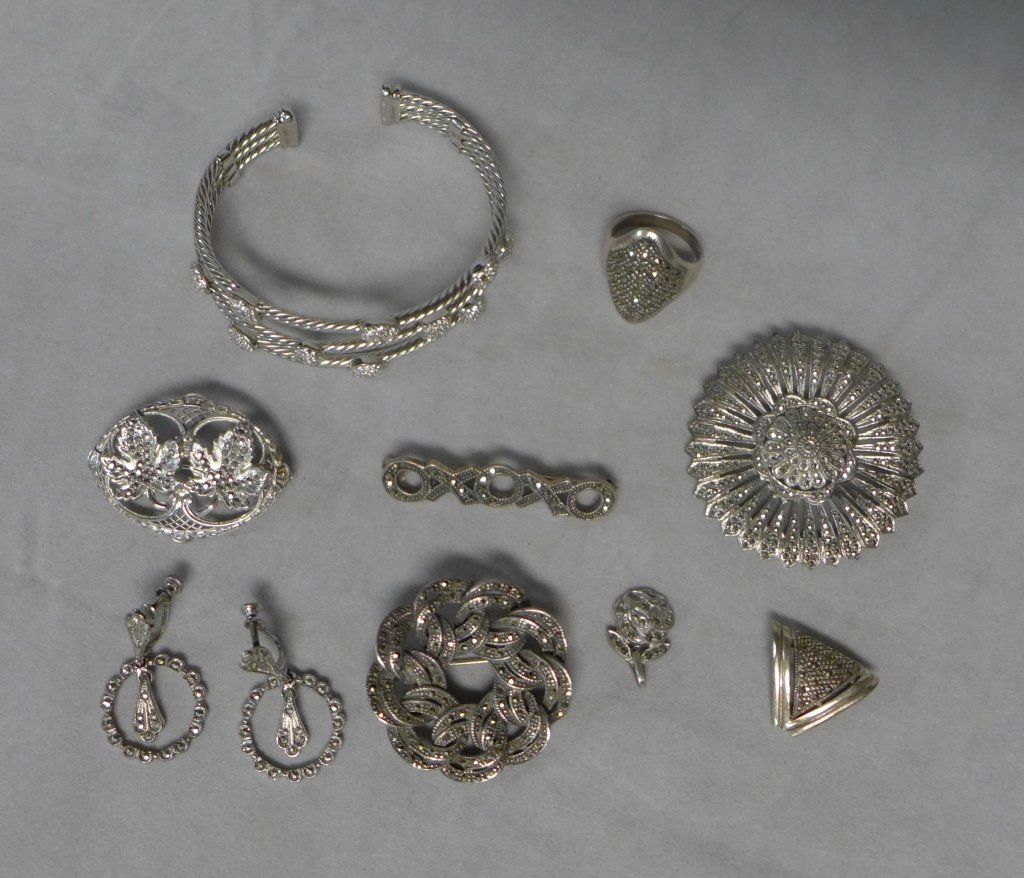 Silver Marcasite Jewelry Assortment: Silver Marcasite Jewelry Assortment.Includes: Cuff bracelet, ring, pins, earrings and pendants.Hallmarks.Total approximate weight: 100 grams.STERLING ASSOCIATES STRIVES TO PROVIDE ACCURATE, OBJECTIVE,