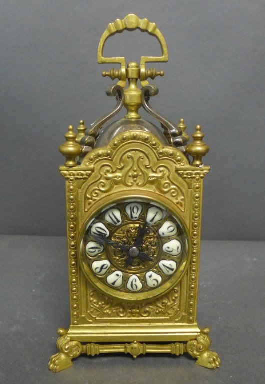 French Gothic Style Carriage Clock: French bronze carriage clock with enameled numbers on front and beveled glass on sides. Back of clock mechanism reads: Hands, French Make, E.M&Co. Circa 1900. Height (not including top handle): 8 1/2"