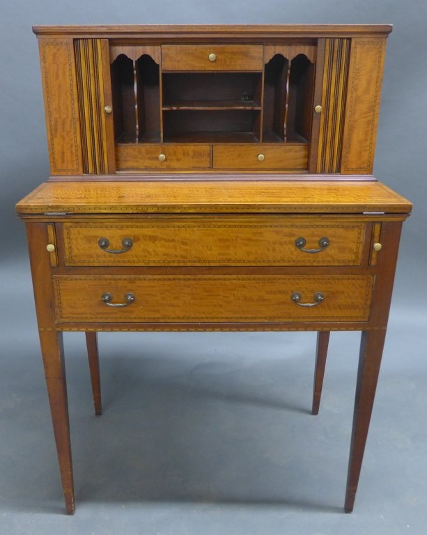 Secretary Flip Top Desk: Antique secretary with flip top writing desk and tambour doors. One knob is loose. With burled wood and inlay accents. Straight tapered legs. Some slight imperfections. Height: 41 3/4", Width: 28", De