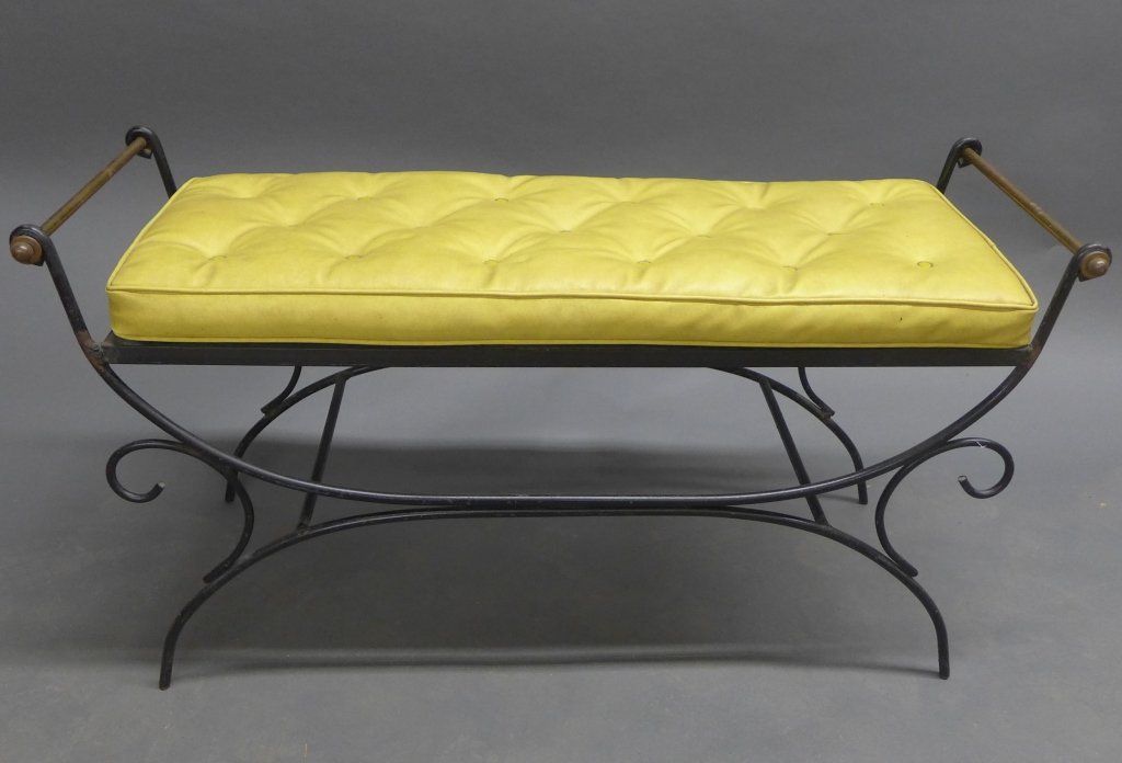 Vintage Iron Bench w/ Cushion: Black painted iron frame with scrolling arms and slat seat. Bronze handles. Removable yellow cushion. Indoor/ Outdoor. Some imperfections. Height: 22", Width: 42", Depth: 15 1/2" (seat, seating, inter
