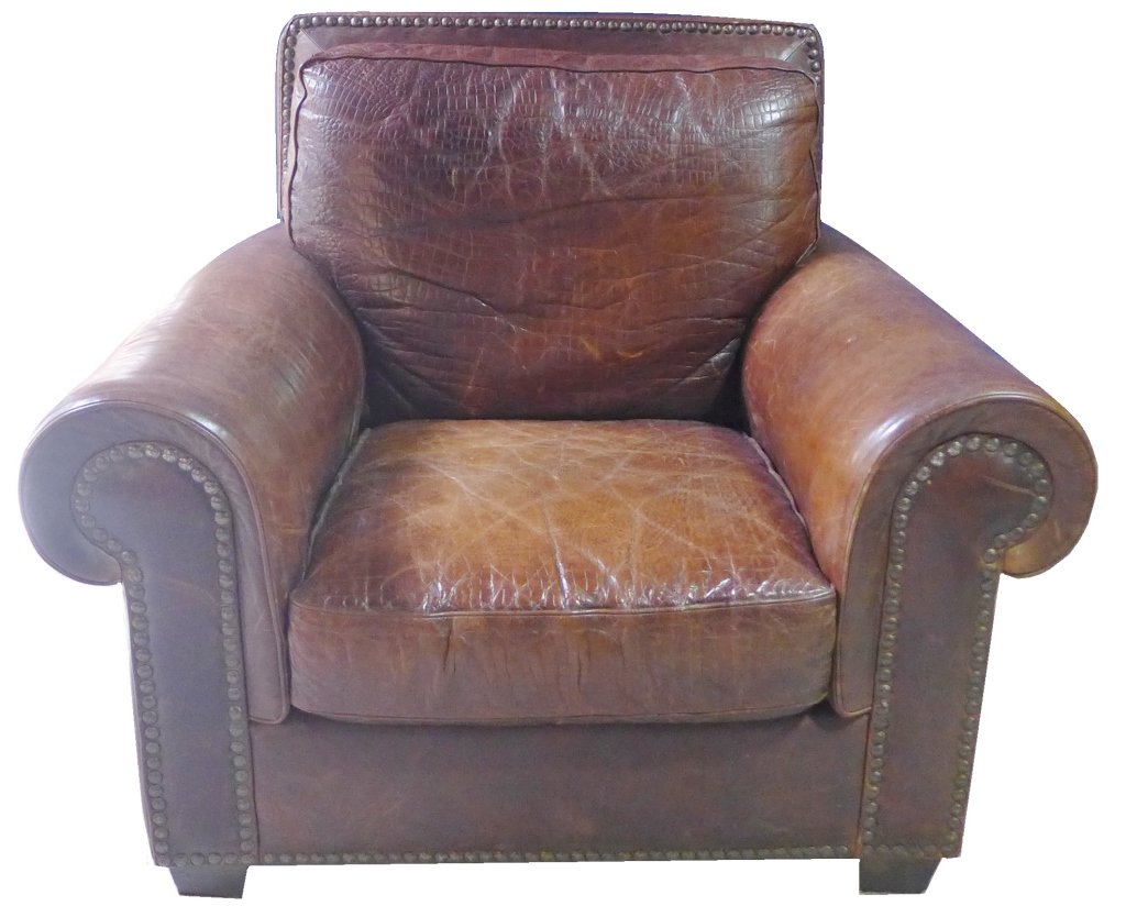 Leather Club Sofa Chair: Beautiful English brown leather chair with deep seating. Stunning textured brown leather. With large decorative nail head accents. Cushions are not removable. No noticeable maker's label. Some slight 