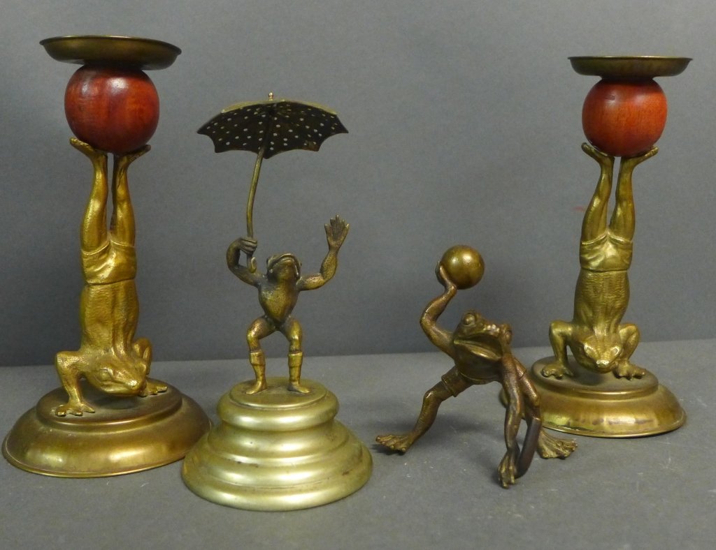Bronze Frog Grouping: Collection includes: -Pair of candlesticks depicting sculpted frogs in bathing suit shorts. The Amphibians are in a handstand pose holding wooden spheres with their feet. Some denting. Height: 7" -Fro